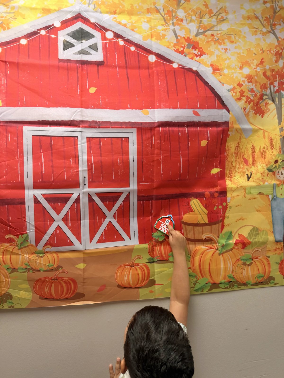 A red barn backdrop with pumpkins set up for Farm week at Latitude's St. Peters ABA center