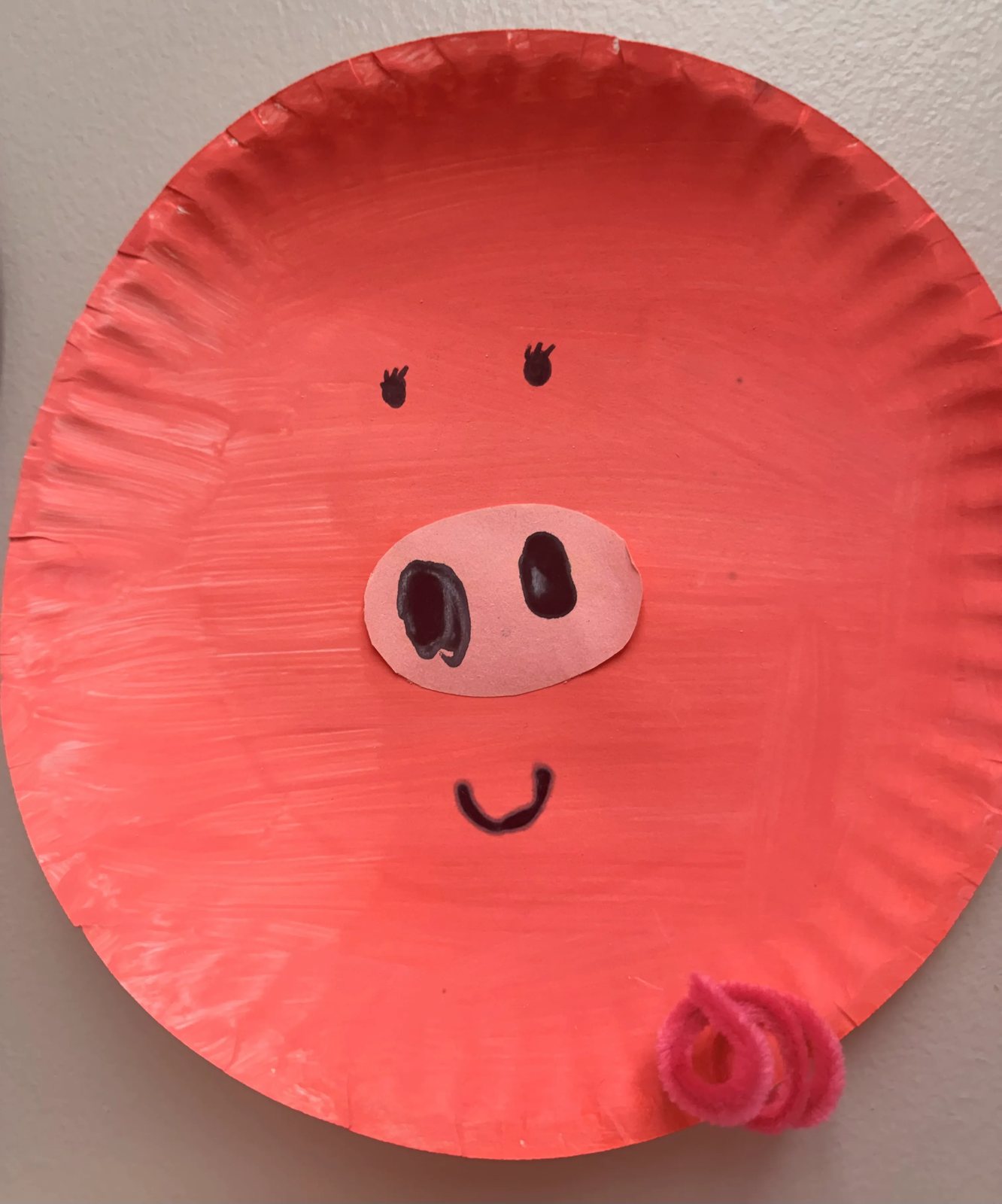 A pink paper plate pig craft made during Farm week at Latitude's St. Peters center
