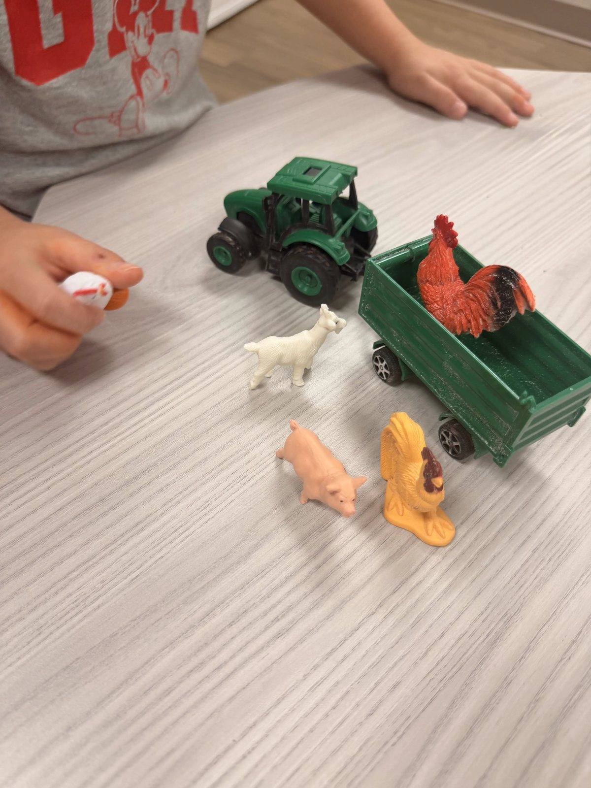 A toy tractor, trailer and farm animals on a table during Farm week at Latitude's St. Peters center